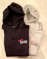 a black and grey hoodie with the words'bucket hitter'on it